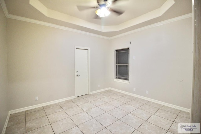 unfurnished room featuring a raised ceiling, ceiling fan, and ornamental molding