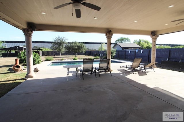 view of patio / terrace featuring ceiling fan and a fenced in pool