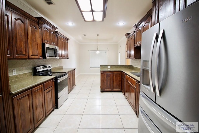 kitchen with decorative backsplash, ornamental molding, decorative light fixtures, light tile patterned flooring, and stainless steel appliances