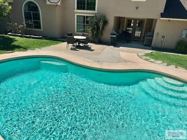 pool featuring a patio area and french doors