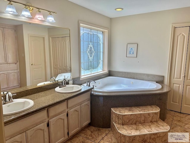 bathroom featuring double vanity, a garden tub, and a sink