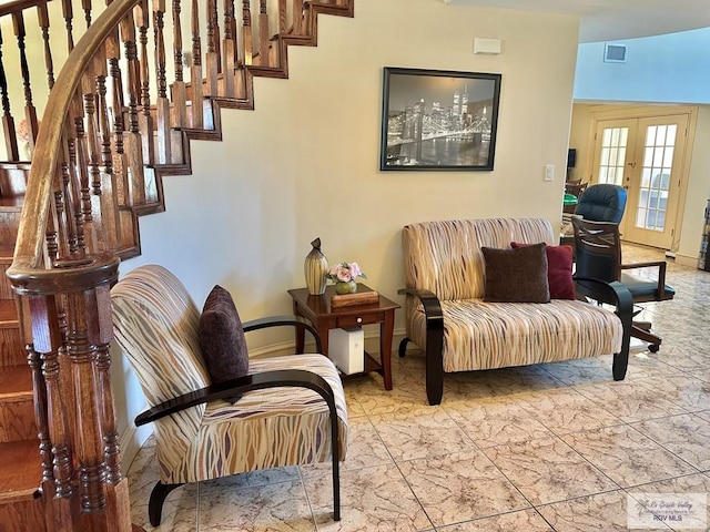 living area with french doors, baseboards, visible vents, and stairs