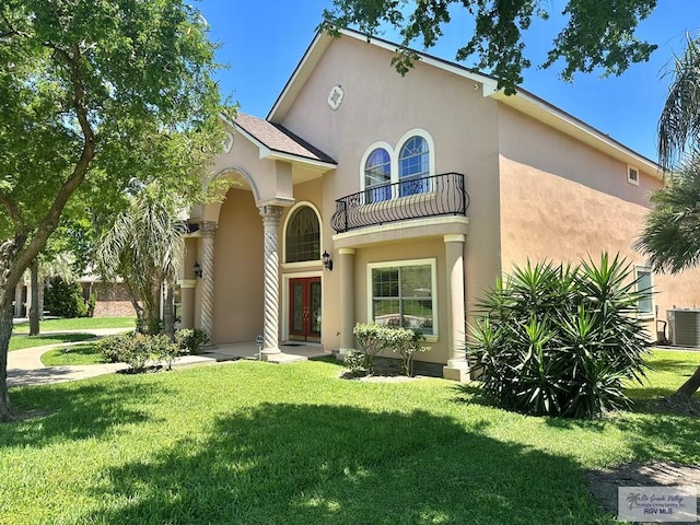 mediterranean / spanish home with a balcony, stucco siding, french doors, cooling unit, and a front yard