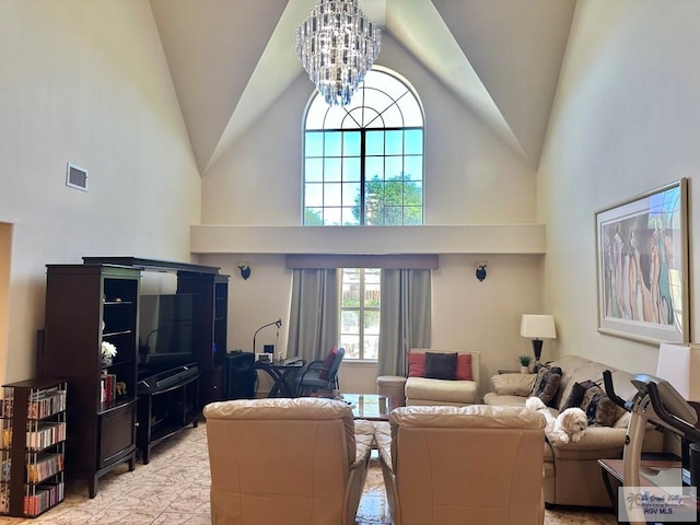 living area with visible vents, high vaulted ceiling, and an inviting chandelier