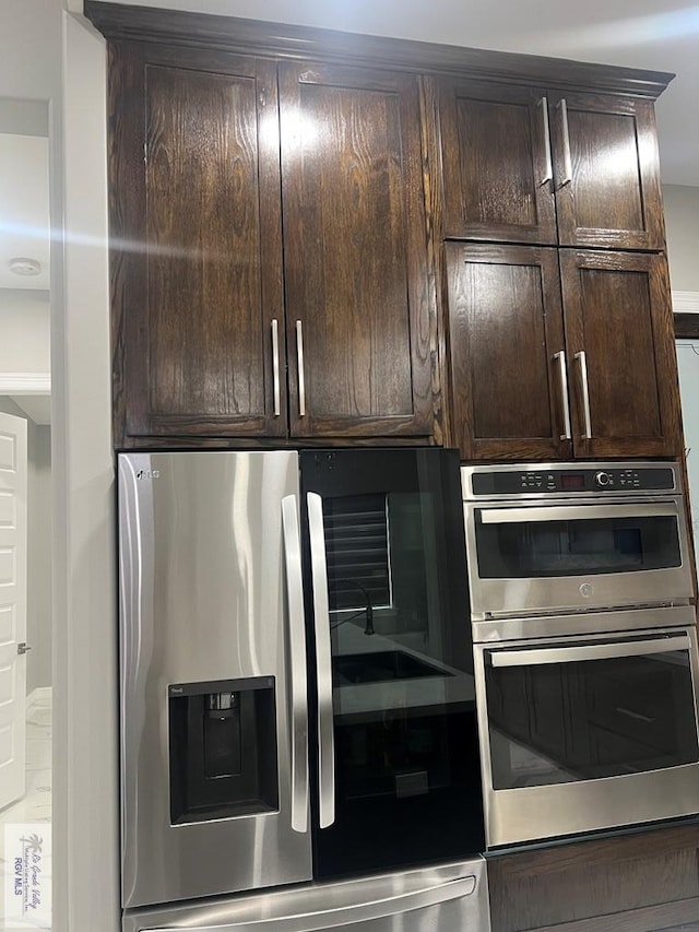 27360 Prudencia St Unit 16, Brownsville, TX 78521 - kitchen with stainless steel appliances and dark brown cabinets