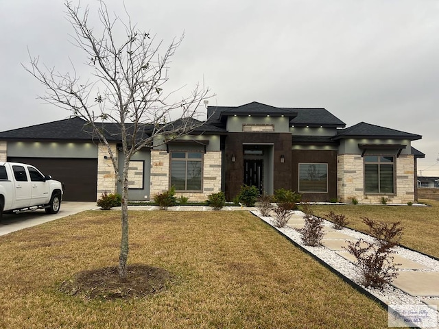 27360 Prudencia St Unit 16, Brownsville, TX 78521 - prairie-style house with stone siding, a garage, a front yard, and driveway