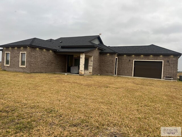 prairie-style house with a garage and a front yard