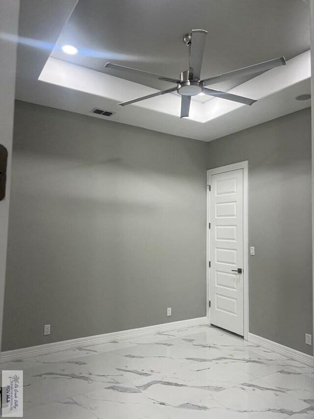 bedroom with a tray ceiling and ceiling fan