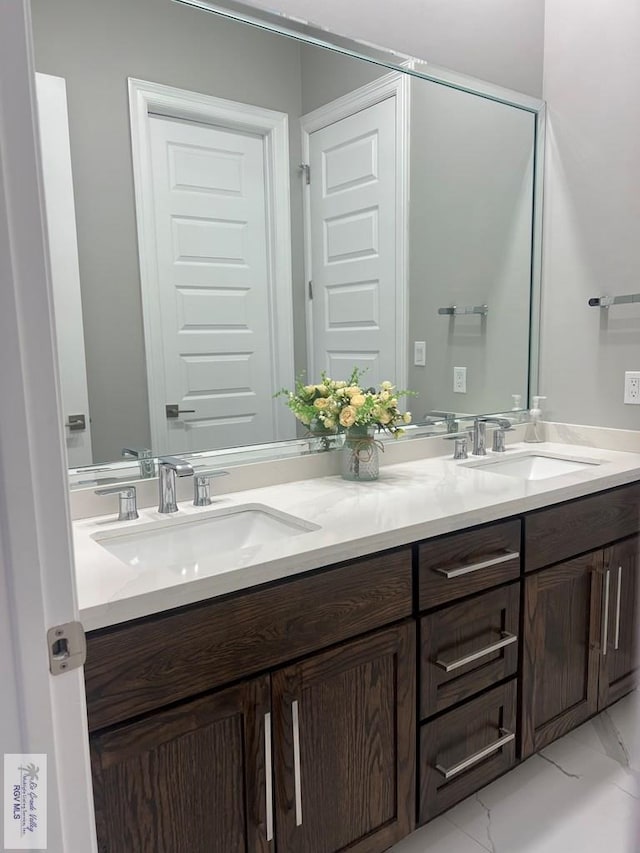 27360 Prudencia St Unit 16, Brownsville, TX 78521 - full bathroom featuring double vanity and marble finish flooring