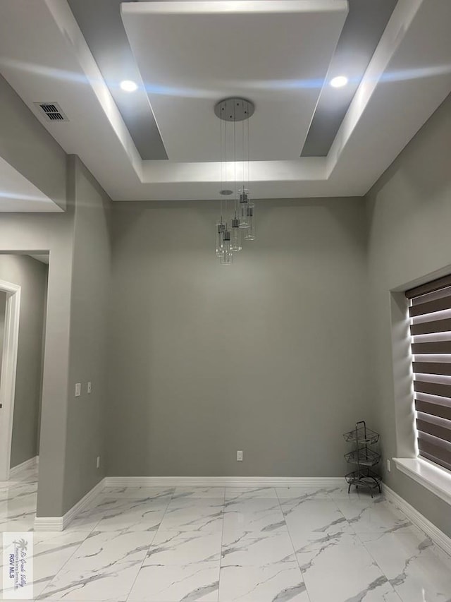 27360 Prudencia St Unit 16, Brownsville, TX 78521 - unfurnished dining area with a tray ceiling, baseboards, light marble finish flooring, and recessed lighting
