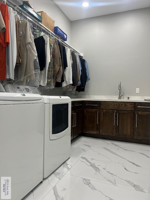 27360 Prudencia St Unit 16, Brownsville, TX 78521 - laundry area with washing machine and clothes dryer, cabinet space, and light marble finish floors