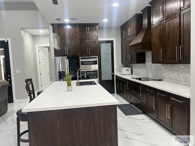 27360 Prudencia St Unit 16, Brownsville, TX 78521 - kitchen featuring stainless steel appliances, light marble finish flooring, backsplash, a sink, and premium range hood