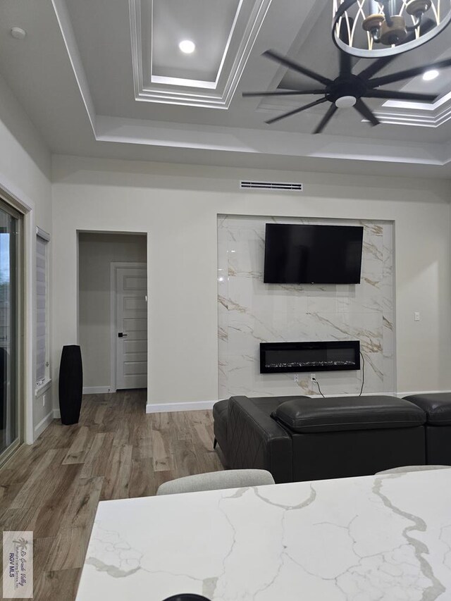 bedroom featuring dark wood-type flooring, ceiling fan, coffered ceiling, connected bathroom, and beamed ceiling