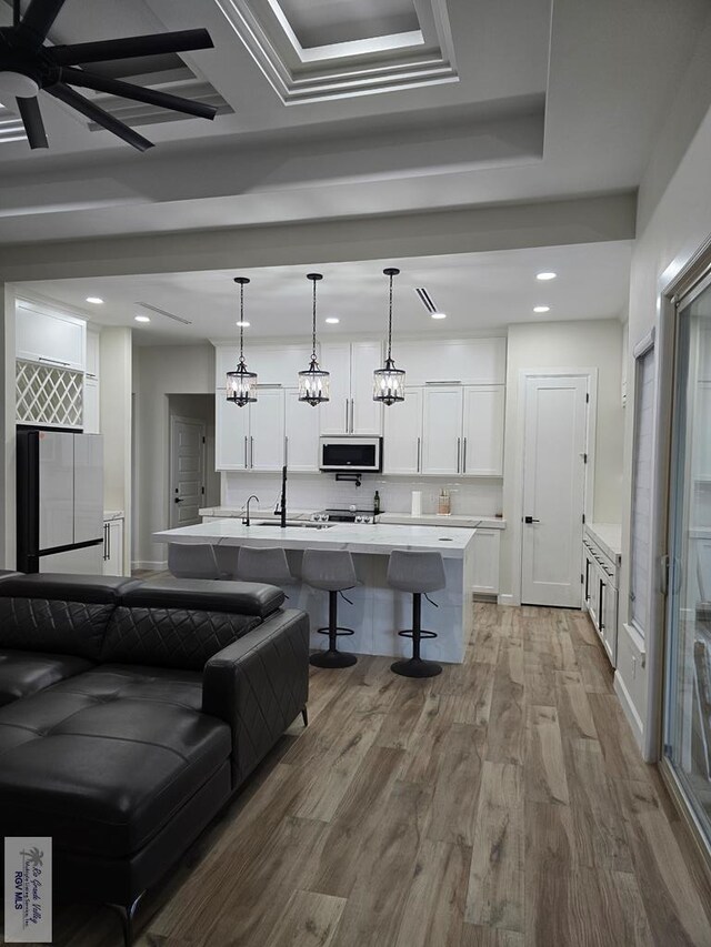 bathroom with hardwood / wood-style flooring, vanity, and combined bath / shower with glass door