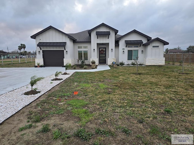 modern farmhouse featuring a garage and a front lawn