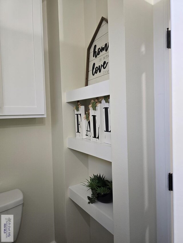 bedroom with ensuite bathroom and light hardwood / wood-style floors