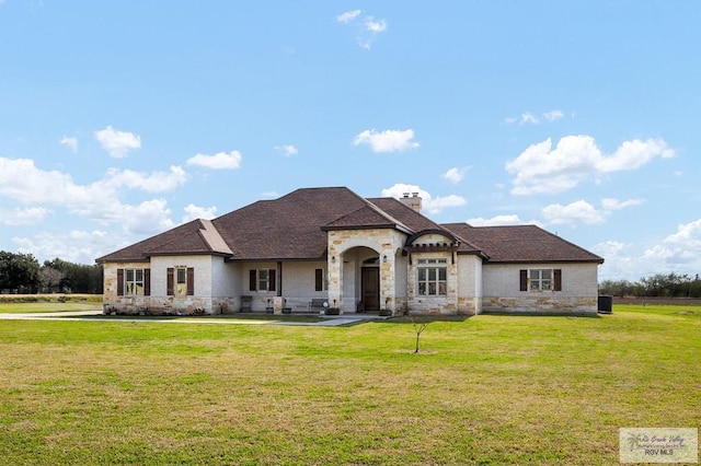 french country style house featuring a front yard