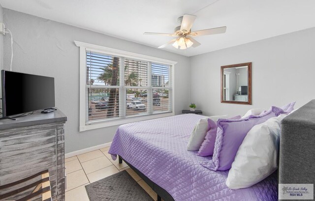 bedroom with ceiling fan and light tile patterned floors