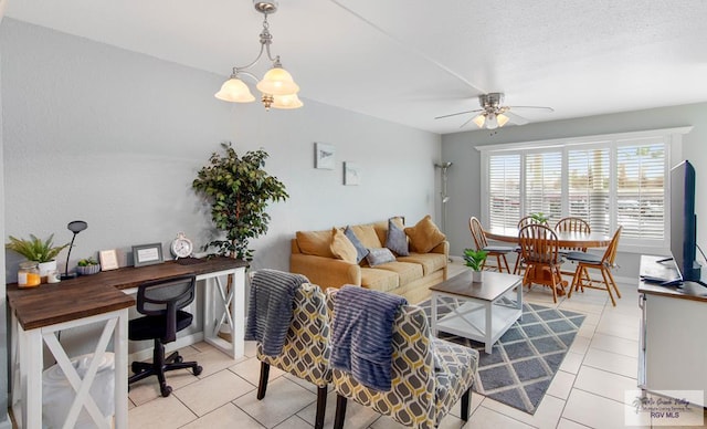 living room featuring ceiling fan with notable chandelier and light tile patterned floors