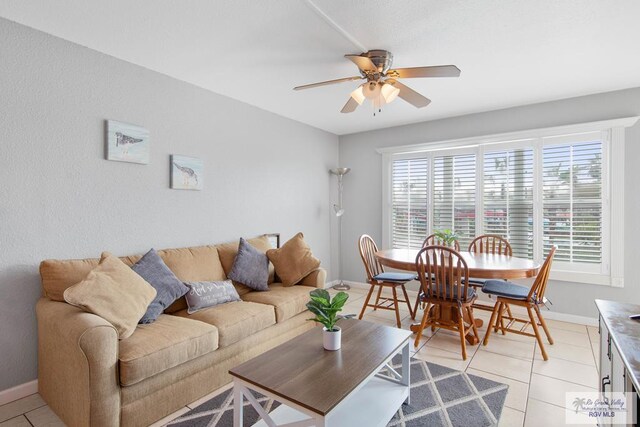 tiled living room with ceiling fan