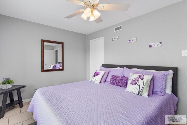 bedroom featuring ceiling fan and light tile patterned flooring