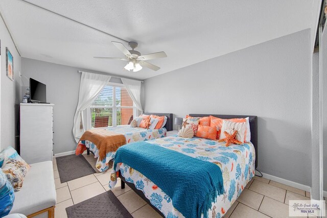 bedroom with ceiling fan and light tile patterned floors