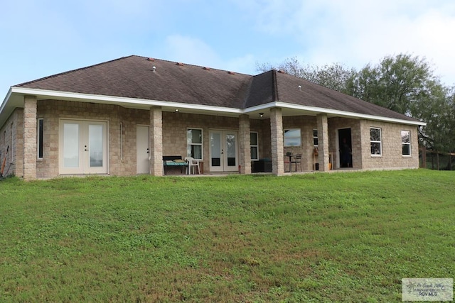 rear view of house with a yard and french doors