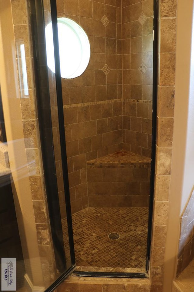 bathroom with a shower with shower door