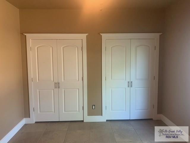 unfurnished bedroom featuring light tile patterned floors