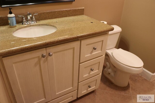 bathroom with tile patterned floors, vanity, and toilet