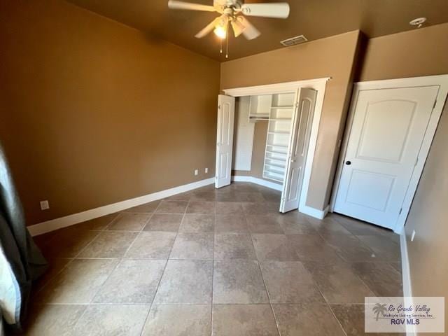 unfurnished bedroom featuring tile patterned floors, ceiling fan, and a closet