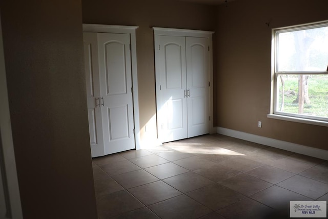 unfurnished bedroom featuring tile patterned flooring