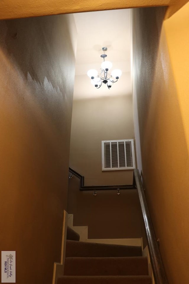 stairway with an inviting chandelier