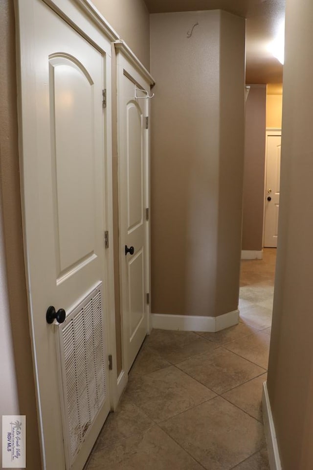 hallway with light tile patterned floors