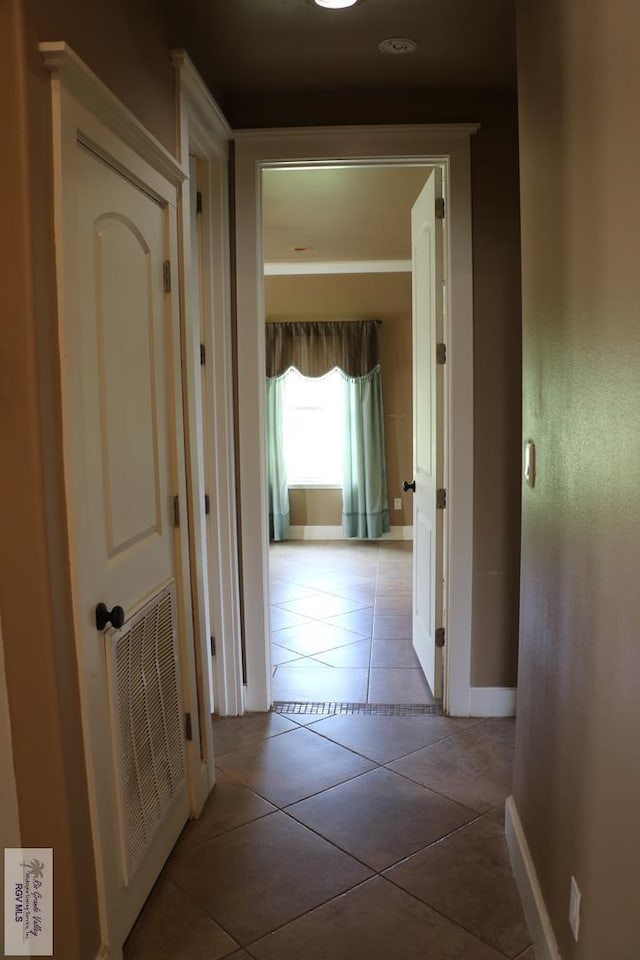 corridor featuring light tile patterned flooring