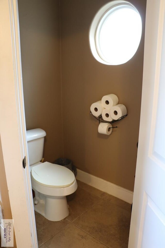 bathroom featuring tile patterned flooring and toilet