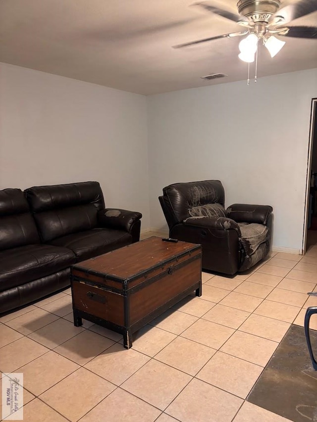 living room featuring light tile patterned floors, a ceiling fan, and visible vents