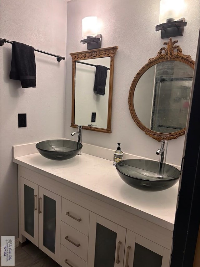 bathroom with double vanity and a sink