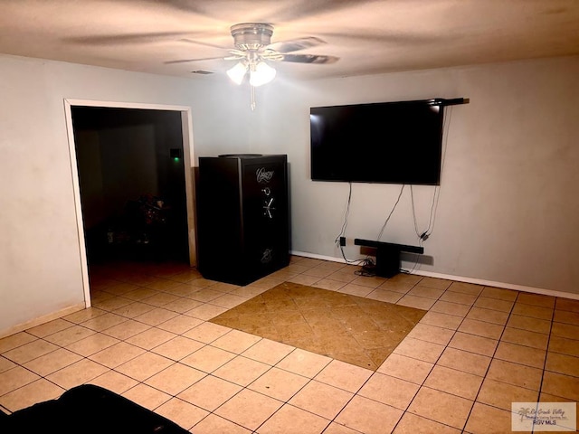 unfurnished living room with light tile patterned floors, baseboards, a ceiling fan, and visible vents