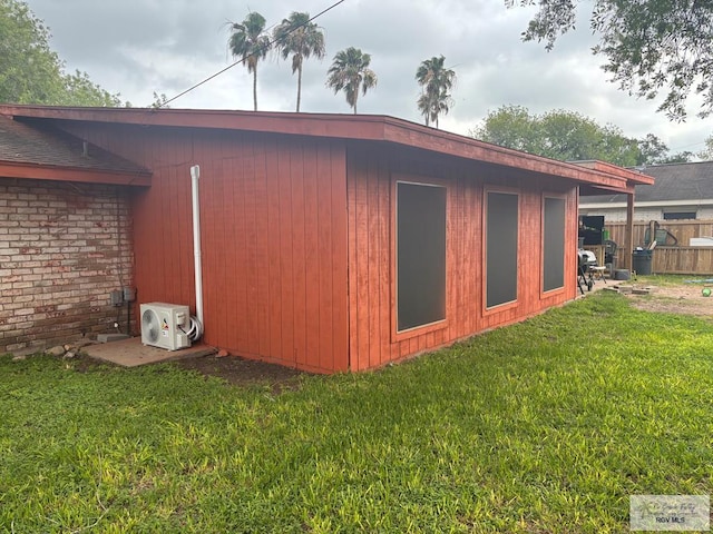 view of outdoor structure featuring fence and ac unit