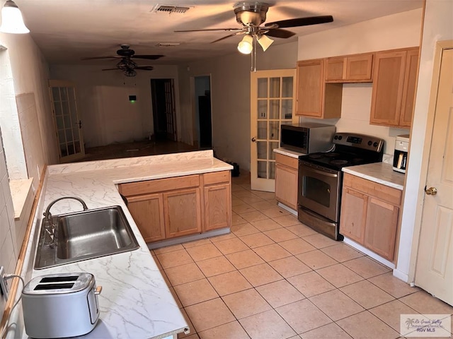 31 Casa De Palmas, Brownsville, TX 78521 - kitchen with appliances with stainless steel finishes, a sink, ceiling fan, and light tile patterned floors