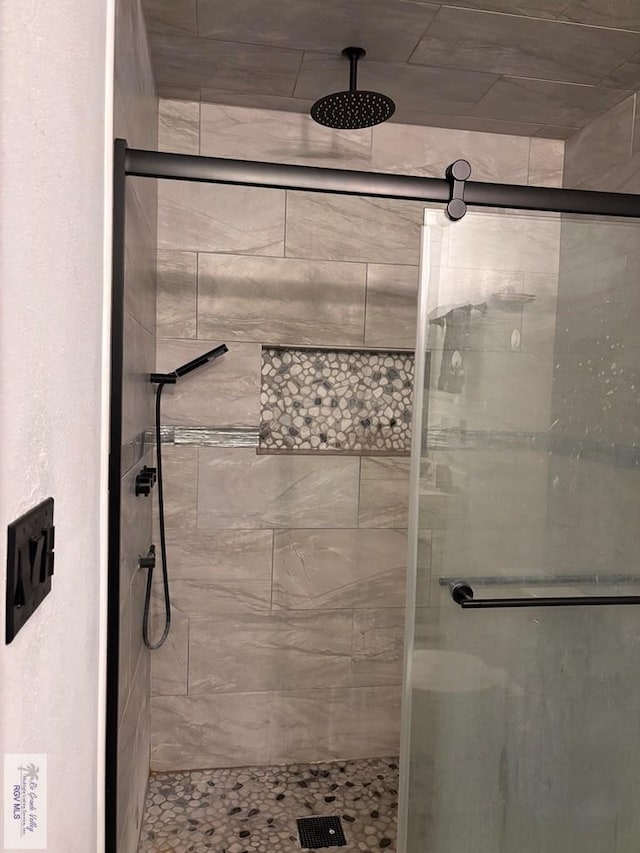 full bath featuring a shower stall