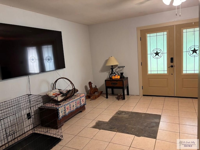 entrance foyer with tile patterned flooring and ceiling fan