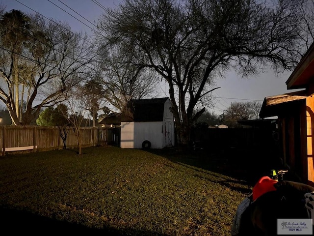 view of yard with a fenced backyard and an outbuilding