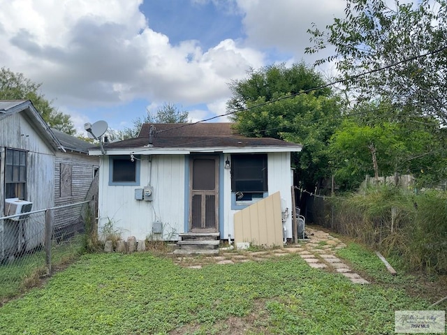 911 Curtis St, Harlingen, TX 78550 - back of property featuring a yard, entry steps, fence, and roof with shingles