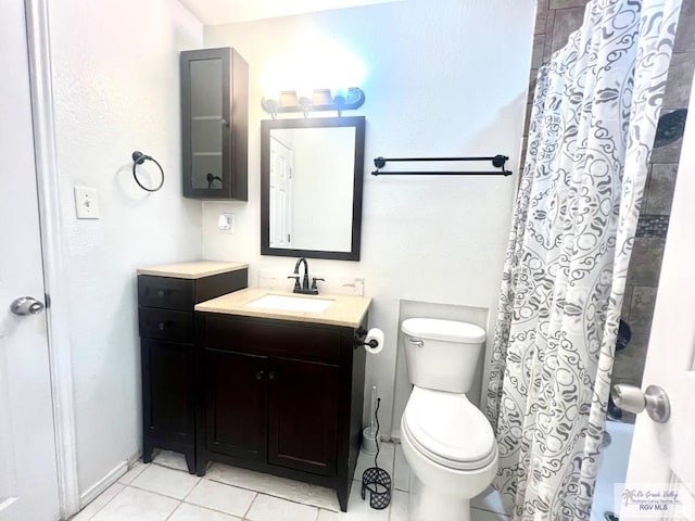 bathroom with tile patterned flooring, vanity, toilet, and a shower with curtain