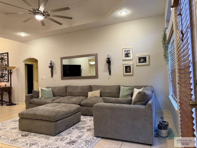 living room with ceiling fan and light tile patterned floors