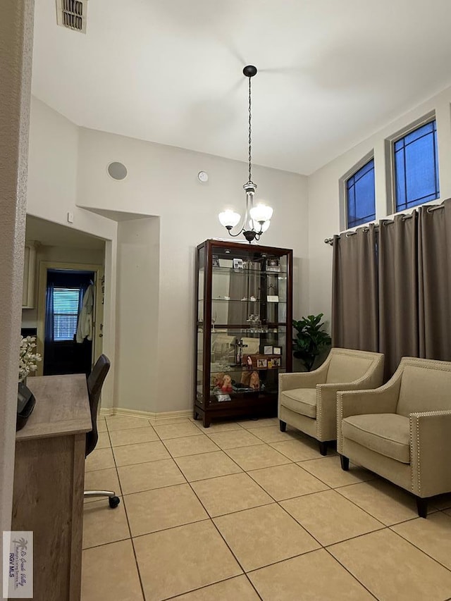 dining area featuring an inviting chandelier and light tile patterned flooring