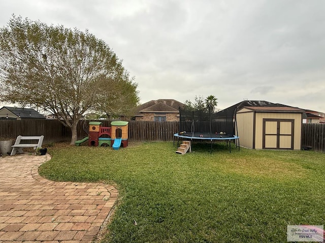 view of yard featuring a playground, a patio, a storage unit, and a trampoline