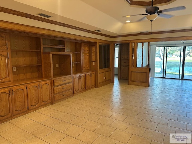 unfurnished room with a raised ceiling, ceiling fan, and light tile patterned flooring